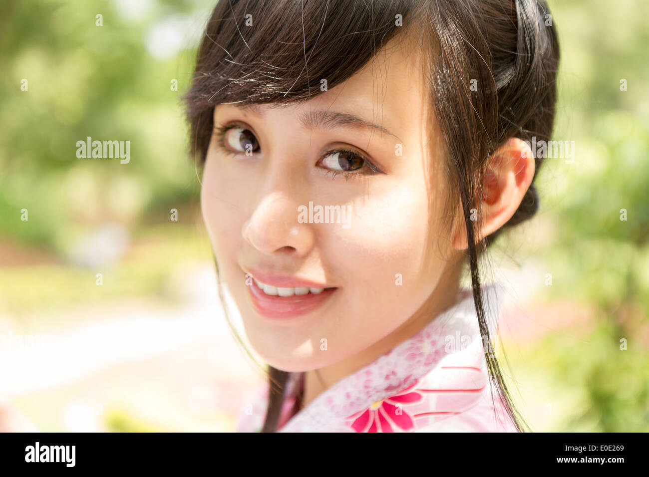 Chinese lady wearing kimono in traditional Japanese style garden Stock