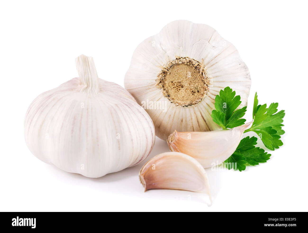 garlic with parsley leaves on a white background Stock Photo - Alamy
