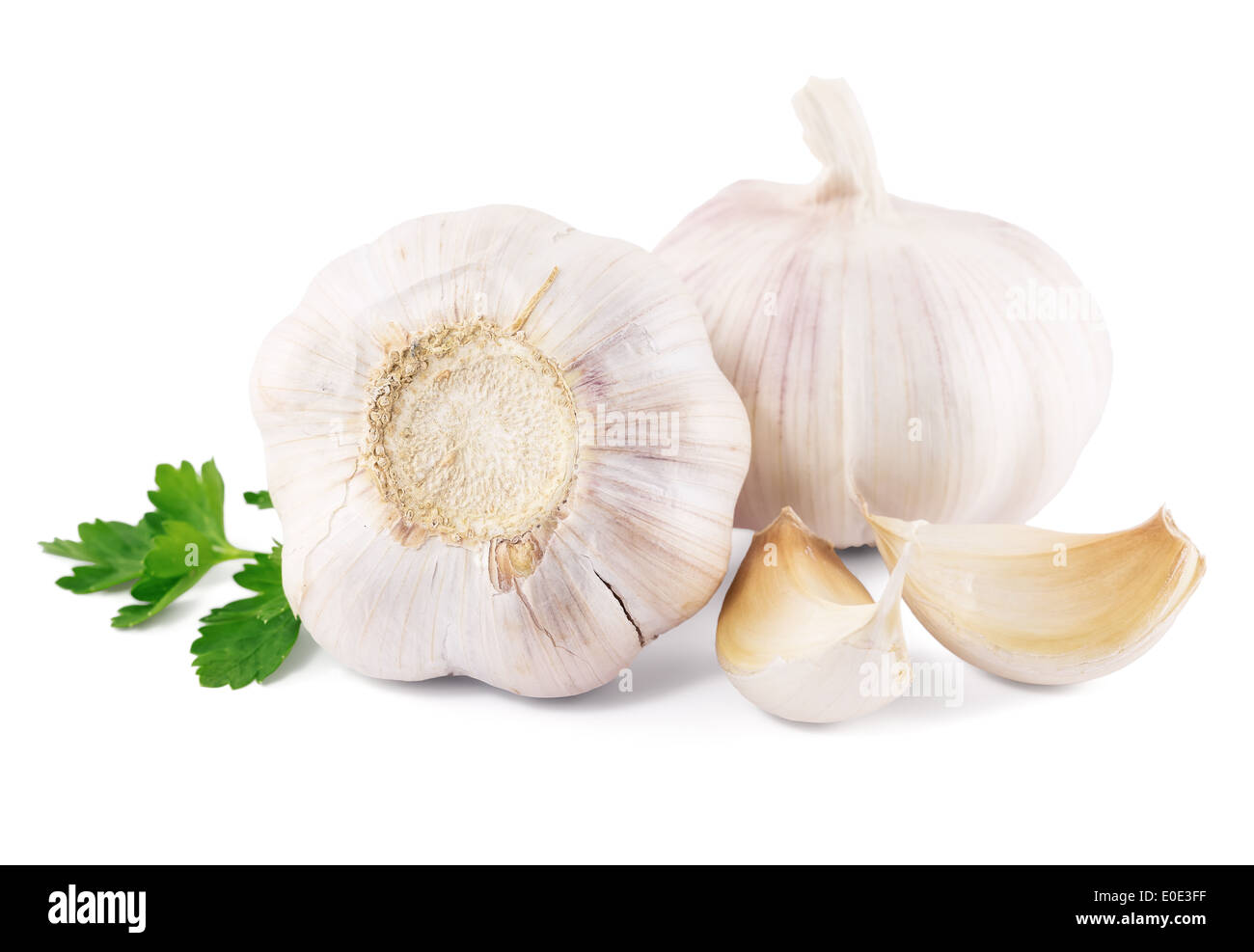 garlic with parsley leaves on a white background Stock Photo - Alamy