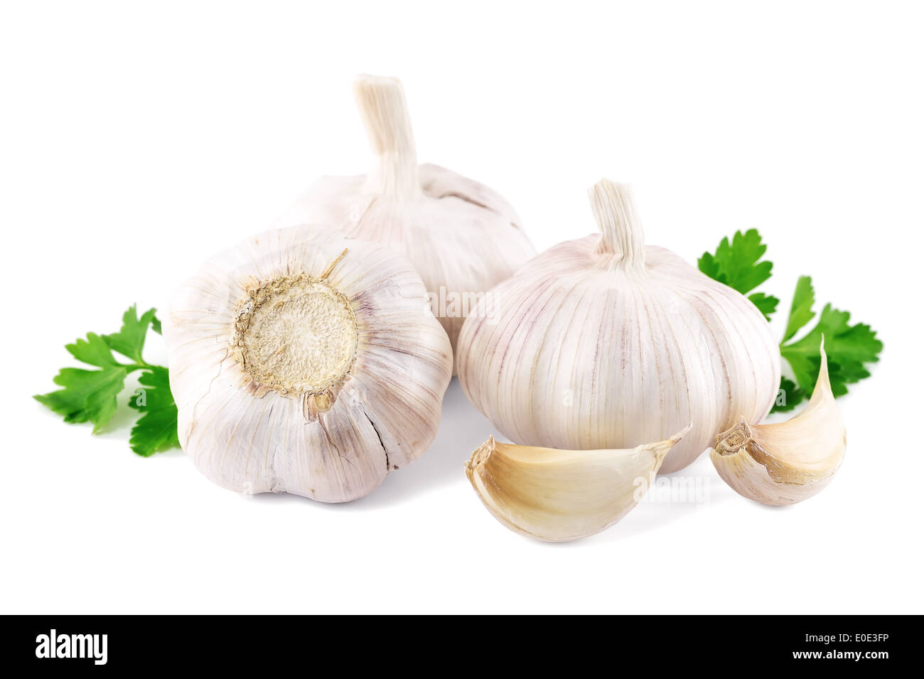 garlic with parsley leaves on a white background Stock Photo - Alamy