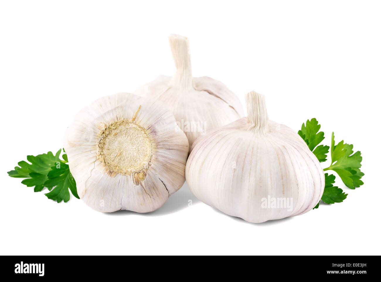 garlic with parsley leaves on a white background Stock Photo - Alamy