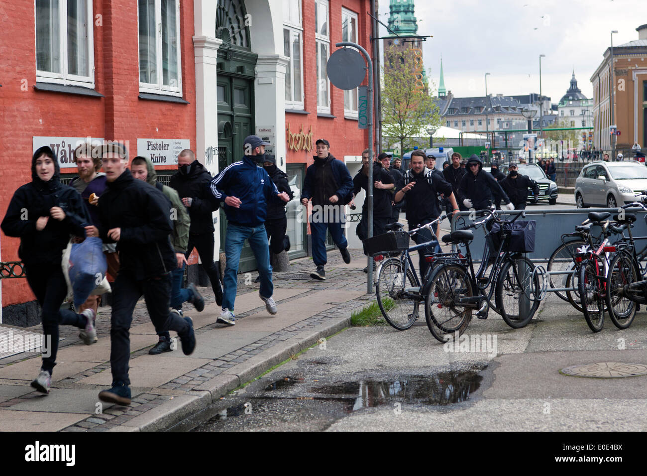 Copenhagen, Denmark – Saturday, May 10, 2014: Escaping police. In the aftermath of the clash between the demonstration at the parliament  this saturday afternoon, police was chasing some of the demonstrators, which took to the side streets, away from the pailiament square. Credit:  OJPHOTOS/Alamy Live News Stock Photo