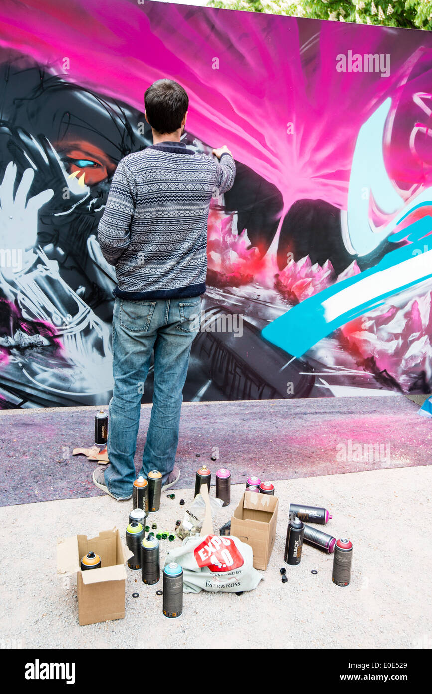 Graffiti artist spraying the wall Stock Photo - Alamy
