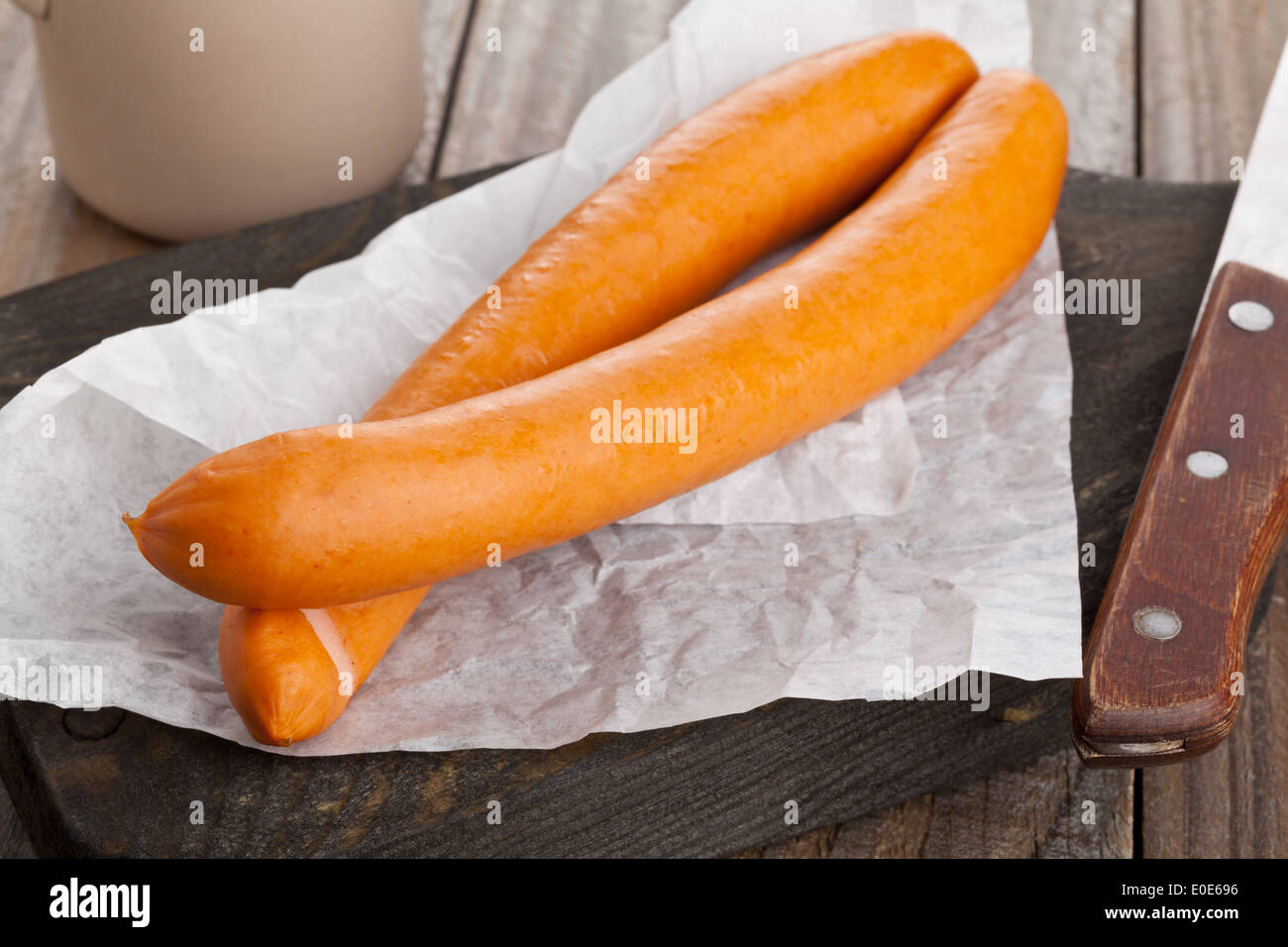 Vienna sausages ('Wiener Würstchen' or 'Frankfurter') on wooden kitchen board Stock Photo
