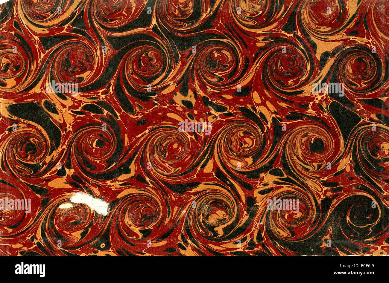 This image features a sheet of marbled paper with a distinct circle ...