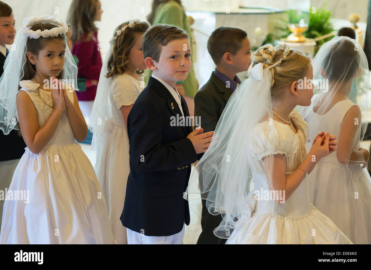 Catholic boys and girls receiving the sacrament of first holy communion. Stock Photo