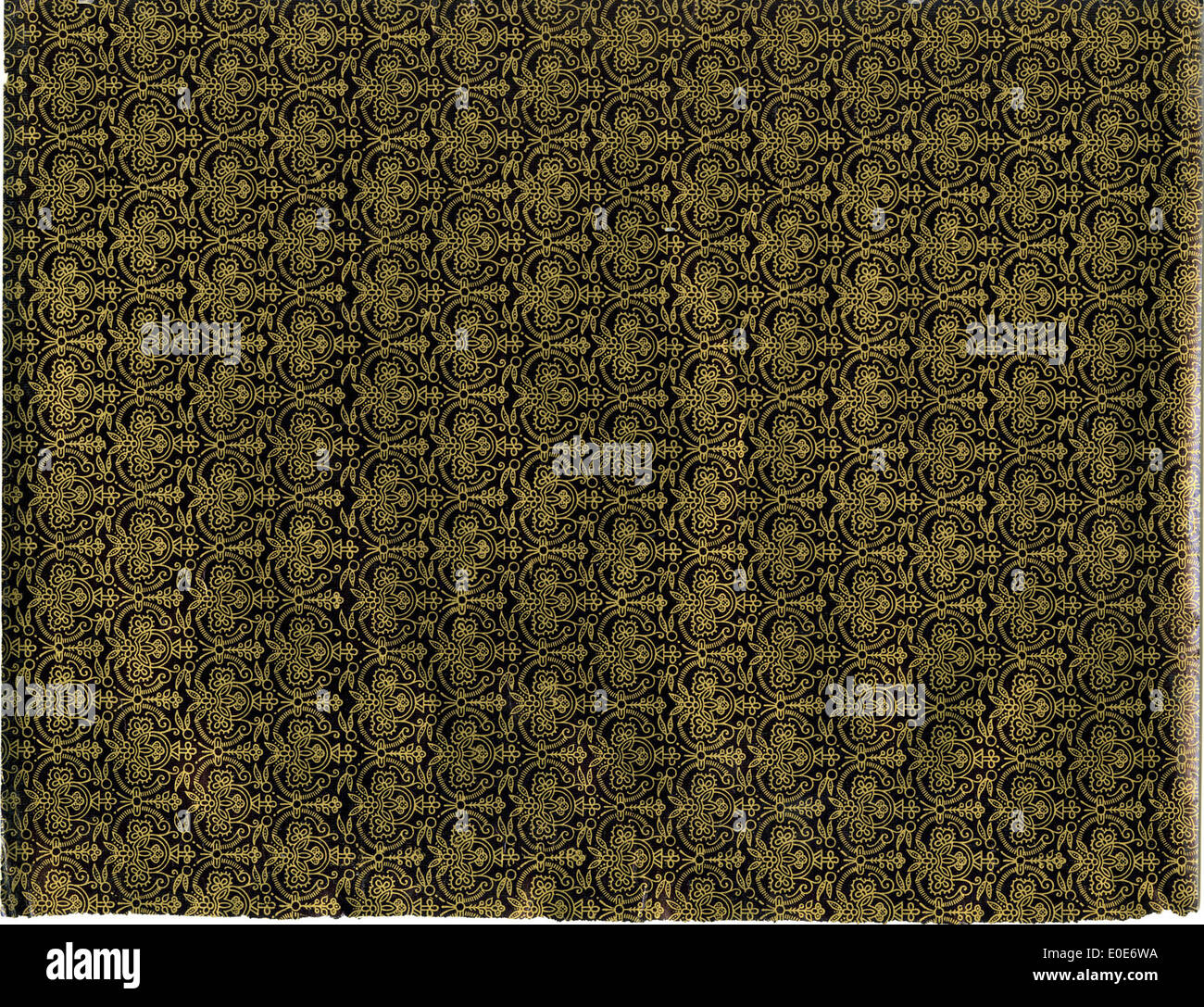 A dark and gold ornamented pattern, showcasing an elegant vintage design with intricate details. This ornamental pattern reflects antique design aesthetics and can be seen in various decorative arts and textiles from earlier periods. Stock Photo