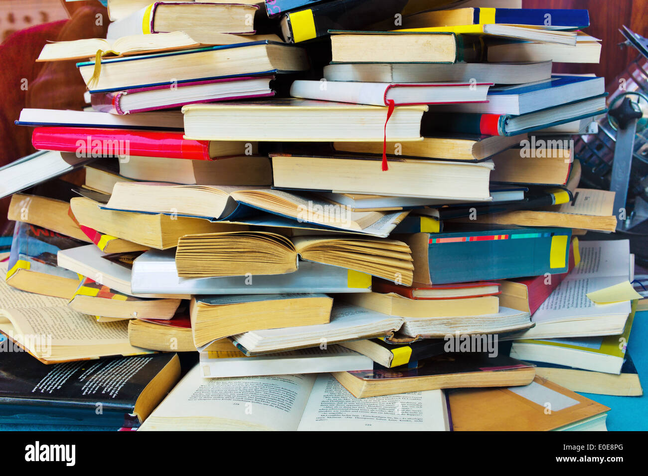 A pile completely whipped and closed books, Ein Stapel voll aufgeschlagen und geschlossener Buecher Stock Photo