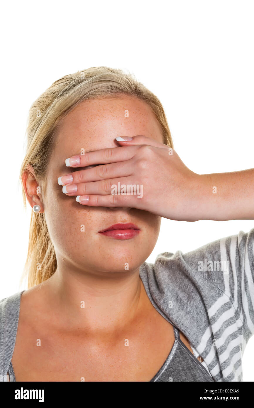 A young woman keeps closed to herself the eyes. Symbolic photo for do not want to see and displacement, Eine junge Frau h Stock Photo