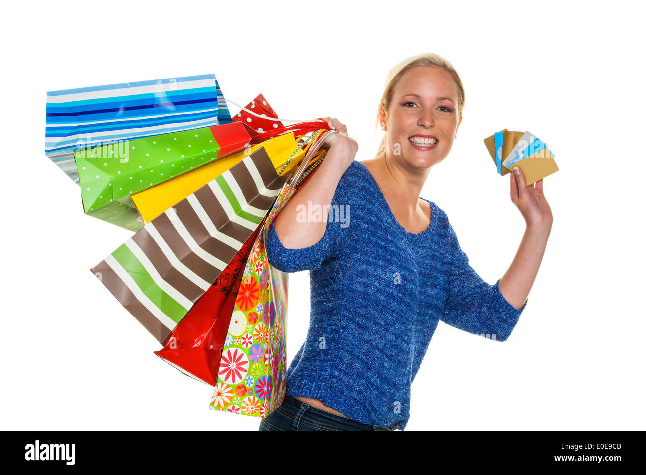A young woman comes back with many carrier bags Stock Photo