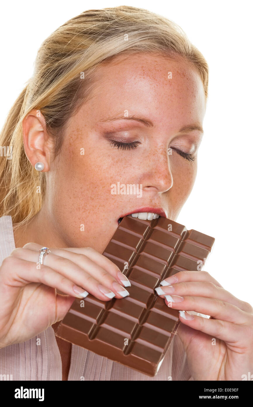 A young woman is completely of pleasure a bar of chocolate, Eine junge Frau ist genussvoll eine Tafel Schokolade Stock Photo