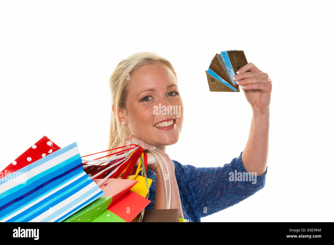 A young woman comes back with many carrier bags of the shopping. With credit cards and plastic money, Eine junge Frau kommt mit Stock Photo