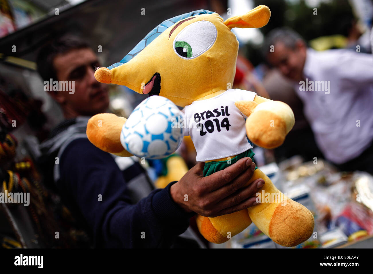Bogota. 9th May, 2014. Image taken on May 9, 2014 shows a man selling a figure of 'Fuleco', the official FIFA World Cup Brazil 2014 mascot, in Bogota, capital of Colombia. Credit:  Jhon Paz/Xinhua/Alamy Live News Stock Photo
