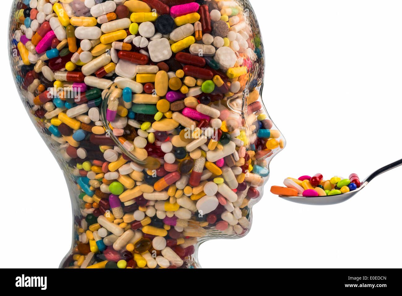 A head of glass with many tablets full. Symbolic photo for drugs, abuse