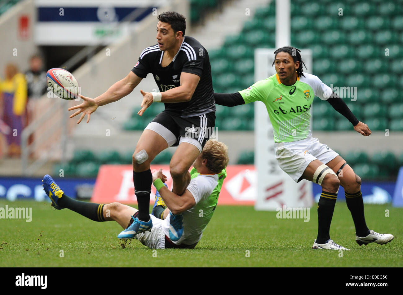 London, UK. 11 May 2014. Bryce Heem of New Zealand passes the ball as Philip Snyman and Justin Geduld try their best to tackle him during the Cup quarter final match between South Africa and New Zealand at the Marriott London Sevens rugby tournament being held at Twickenham Rugby Stadium in London as part of the HSBC Sevens World Series. Photo by Roger Sedres/ImageSA Stock Photo