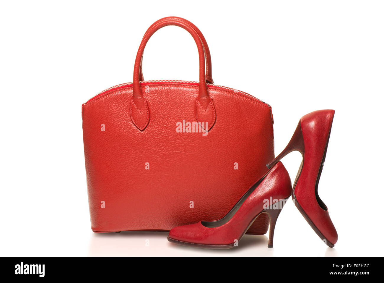 Woman accessories on white background, red handbag and high heels Stock