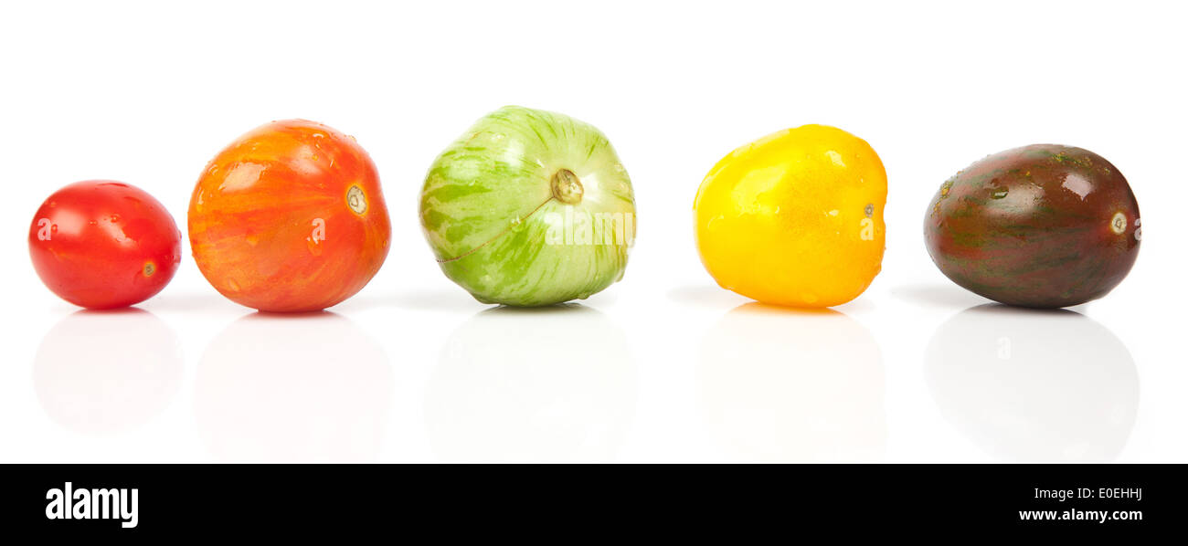 wet tomatoes in a row isolated over white Stock Photo - Alamy