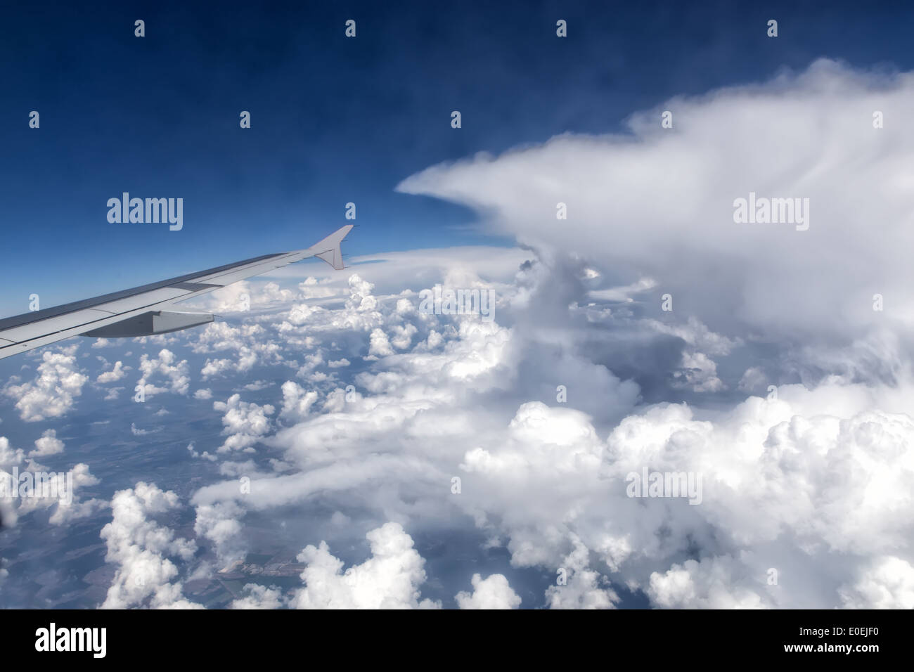 View over the clouds from the window of the plane Stock Photo - Alamy