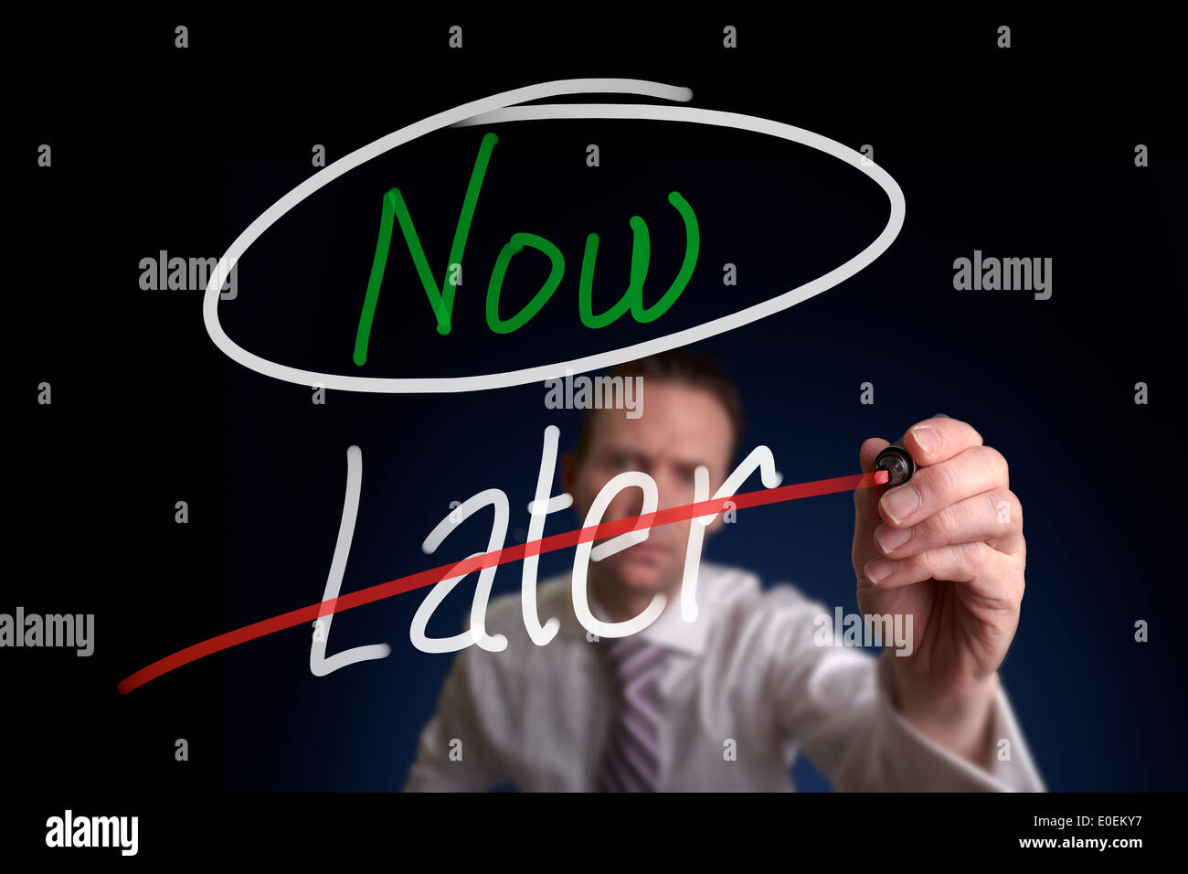 A businessman writing a, Choosing Now instead of Later, concept. Stock Photo