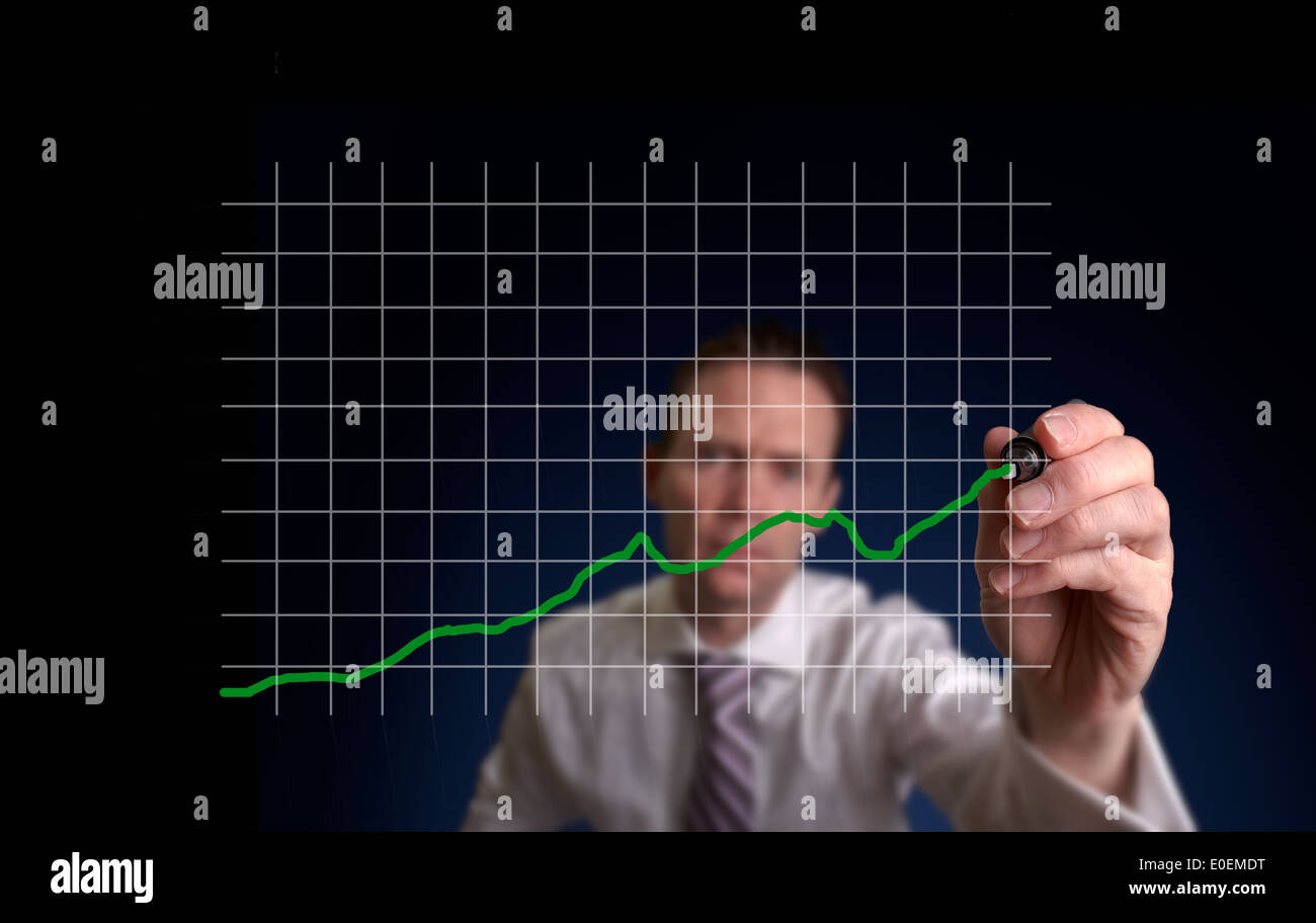 Businessman hand drawing a virtual chart on a clear screen. Stock Photo