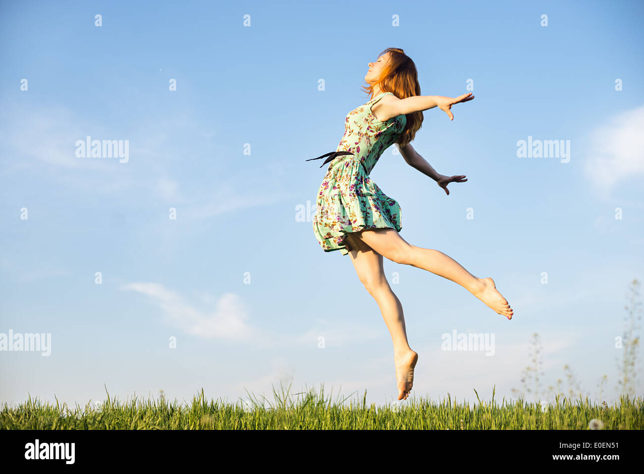 Happy Young Woman Jumping Stock Photo - Alamy