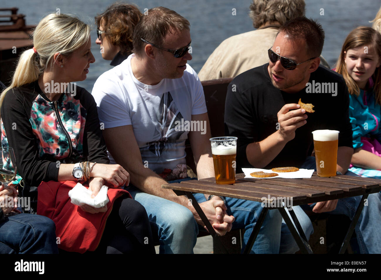 People resting and drinking beer, Prague tourists outside street bar Stock Photo