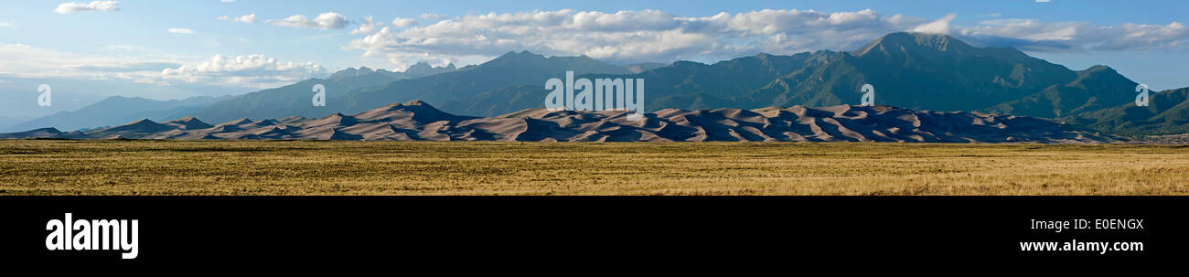 Panorama of grass, dunes and Sangre de Cristo Mountains, Great Sand Dunes National Park and Preserve, Colorado USA Stock Photo