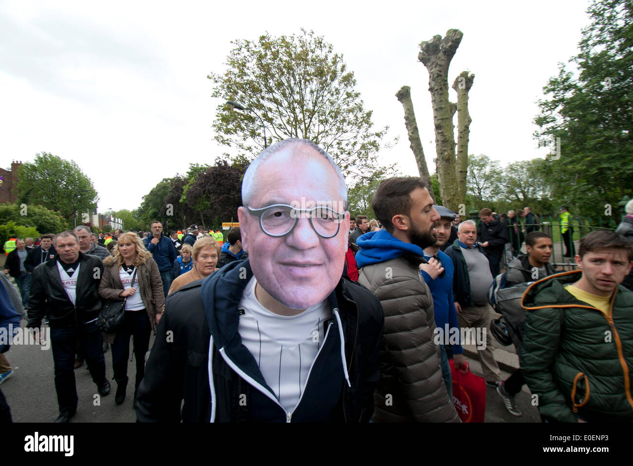 London, UK. 11th May, 2014. A Fulham supporter holds a mask of German manager Felix Magath  arrives for the match between relegated Fulham and Crystal Palace FC on the last day of the English Premier league at Craven Cottage Stock Photo
