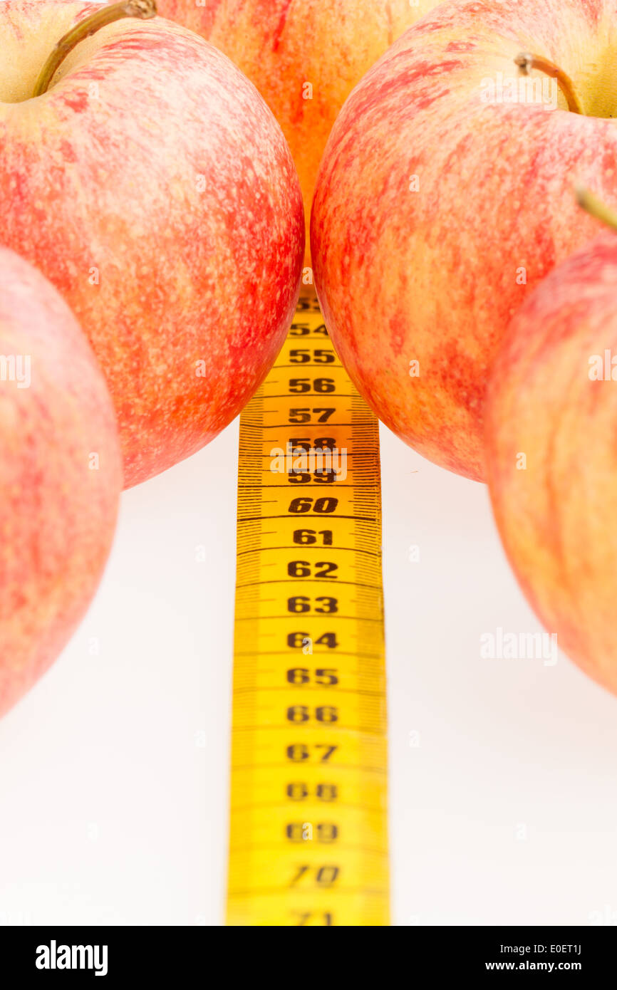 Apple diet, red apples with a yellow tapemeasure Stock Photo Alamy