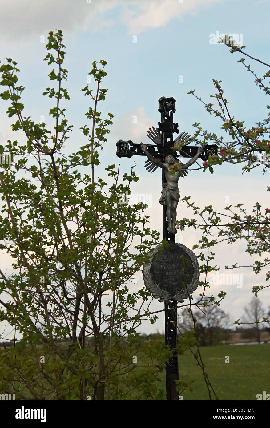 Cross with Jesus in the nature on spring Stock Photo