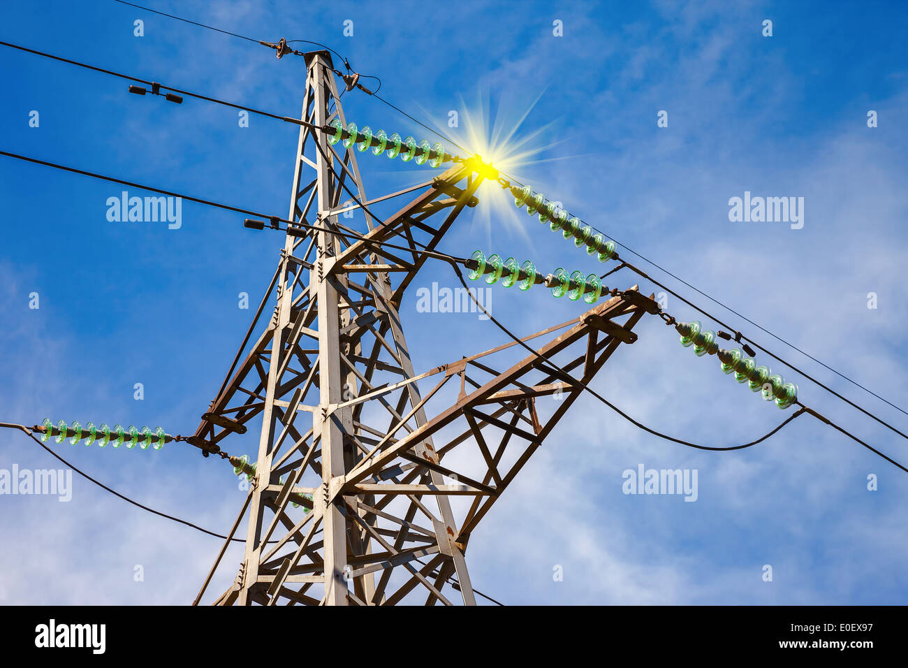 High voltage electric tower against blue sky Stock Photo - Alamy