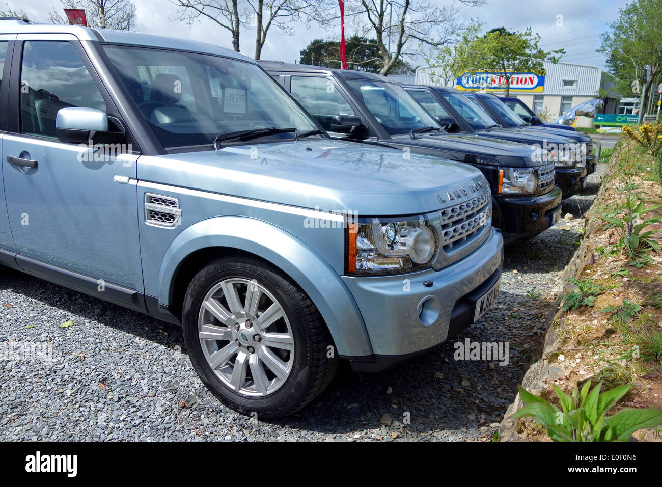 Land Rovers for sale on a second hand car sales forcourt Stock Photo