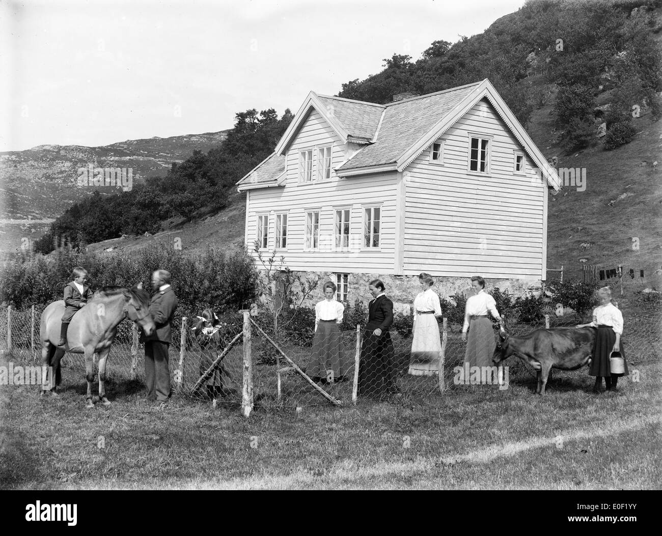 House and family, ca 1890-1910. Stock Photo