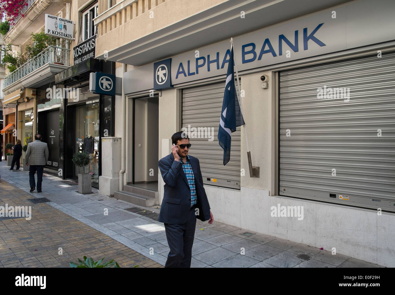 alpha bank cash money dispenser person bank greece Stock Photo