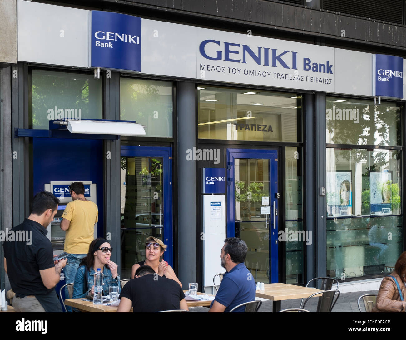 geniki national bank cash dispenser person greece Stock Photo