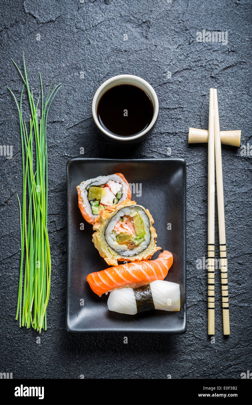 Fresh sushi, dark ceramic and chopstick Stock Photo