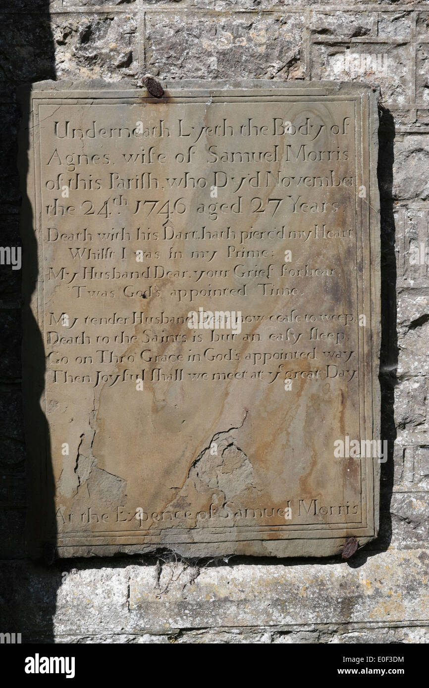 Slate memorial plaque on the outside of  St Rhidian and St Illtyd church at  Llanrhidian on the Gower peninsular in Wales. 18th century Stock Photo