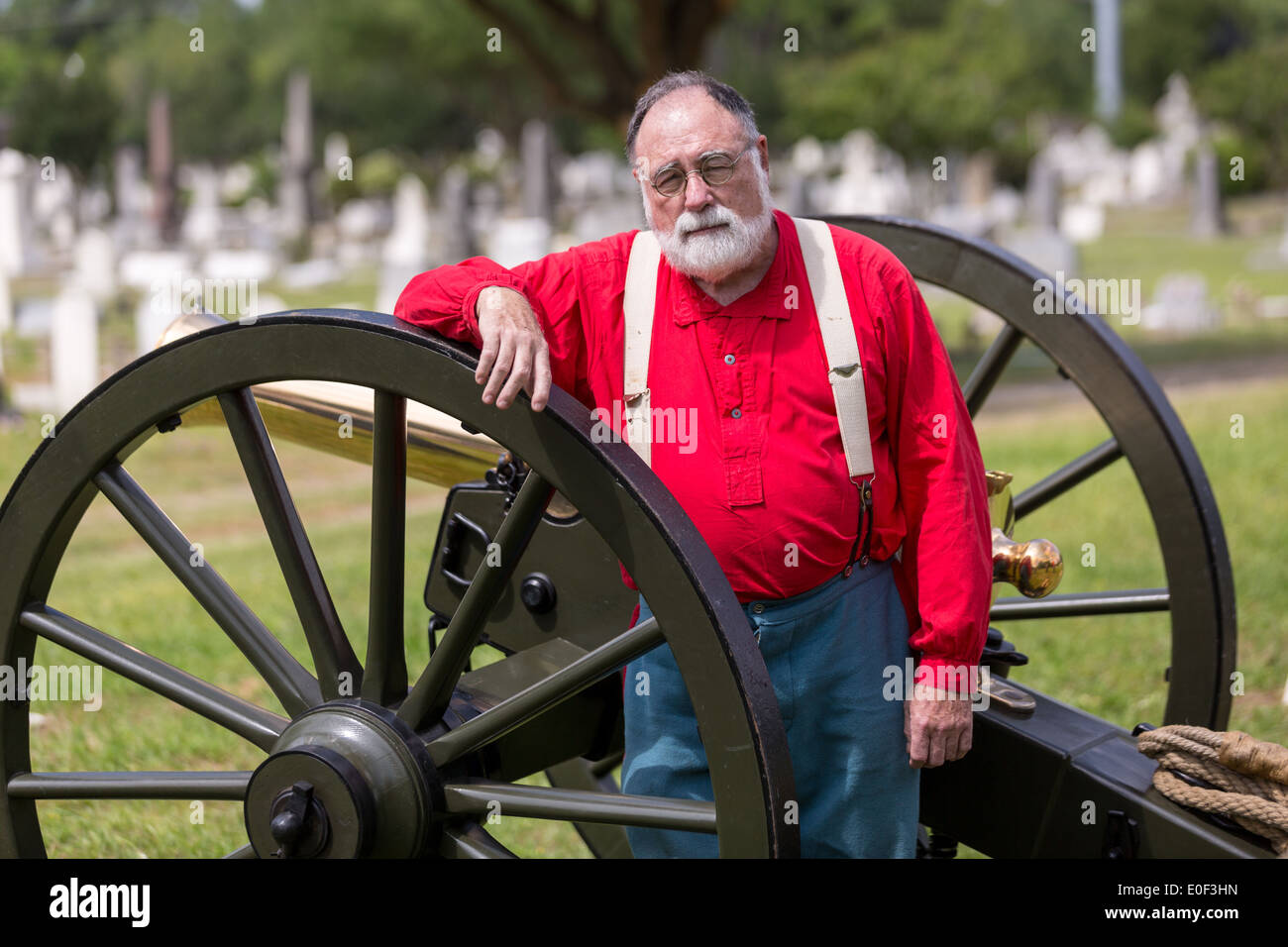 A Civil War re-enactor poses with a cannon during Confederate Memorial Day at Magnolia Cemetery April 10, 2014 in Charleston, SC. Stock Photo