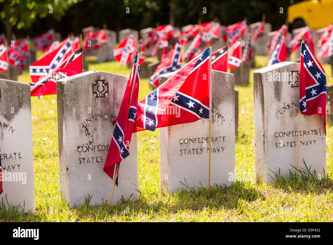 Confederate rebel flags decorate grave markers of soldiers killed in the US Civil War during Confederate Memorial Day at Magnolia Cemetery April 10, 2014 in Charleston, SC. Confederate Memorial Day honors the approximately 258,000 Confederate soldiers that died in the American Civil War. Stock Photo