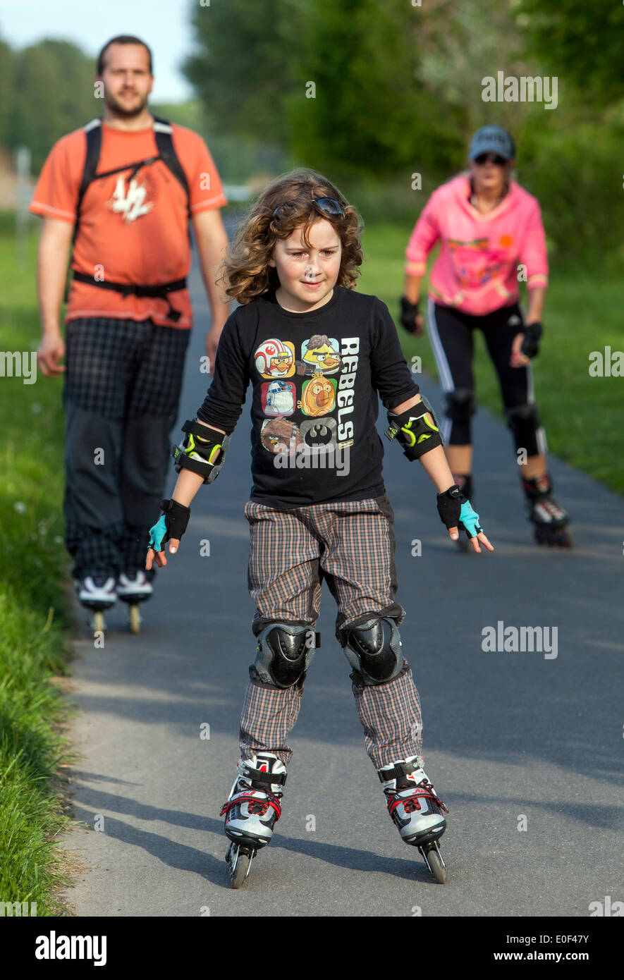 Roller skating child, family on trail Stock Photo Alamy