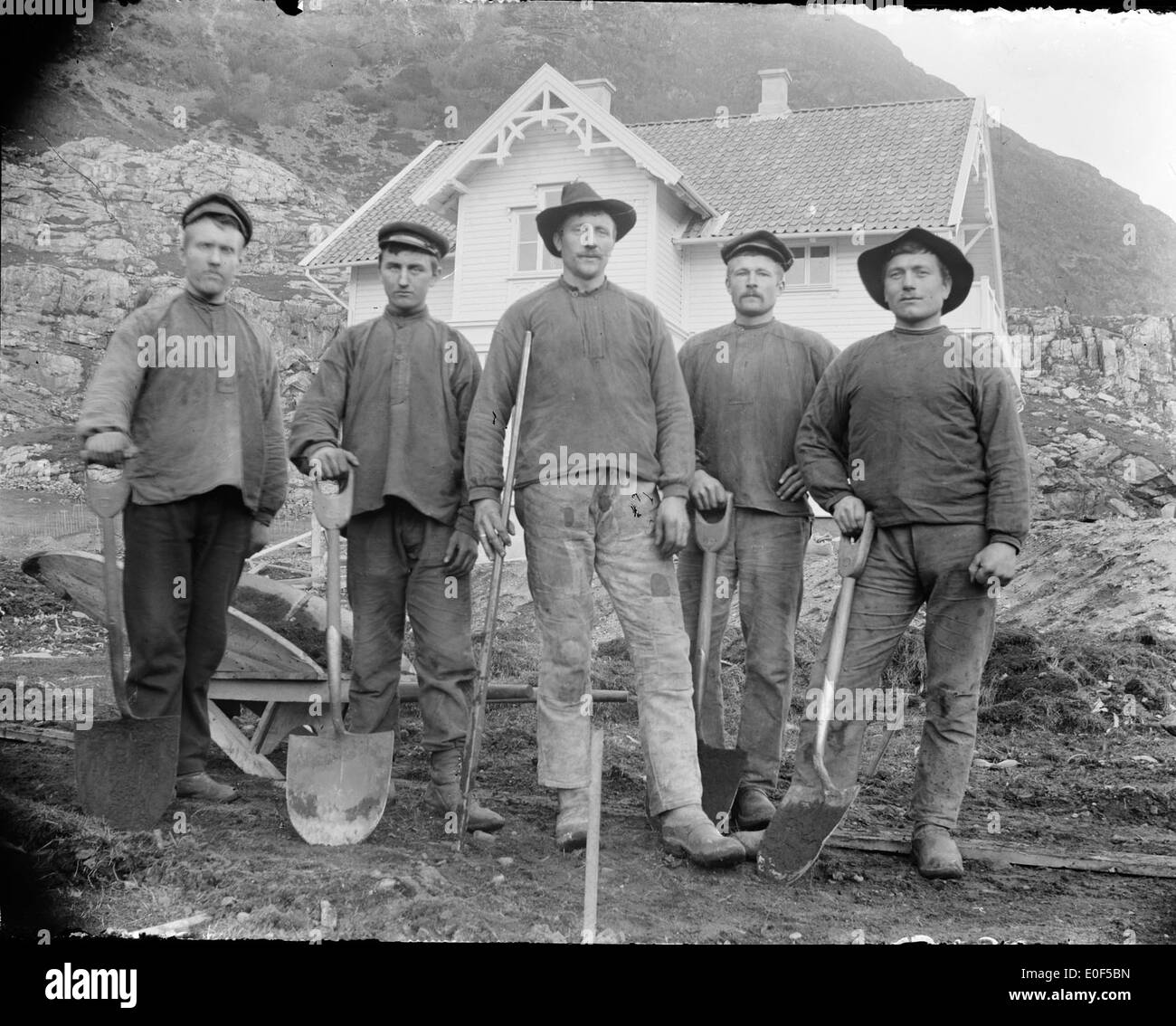 This title describes an alternative photography image showing a group of workers in a historic Norwegian setting, taken by Mads Vie, with old photographic techniques capturing the moment in Sogn og Fjordane. Stock Photo
