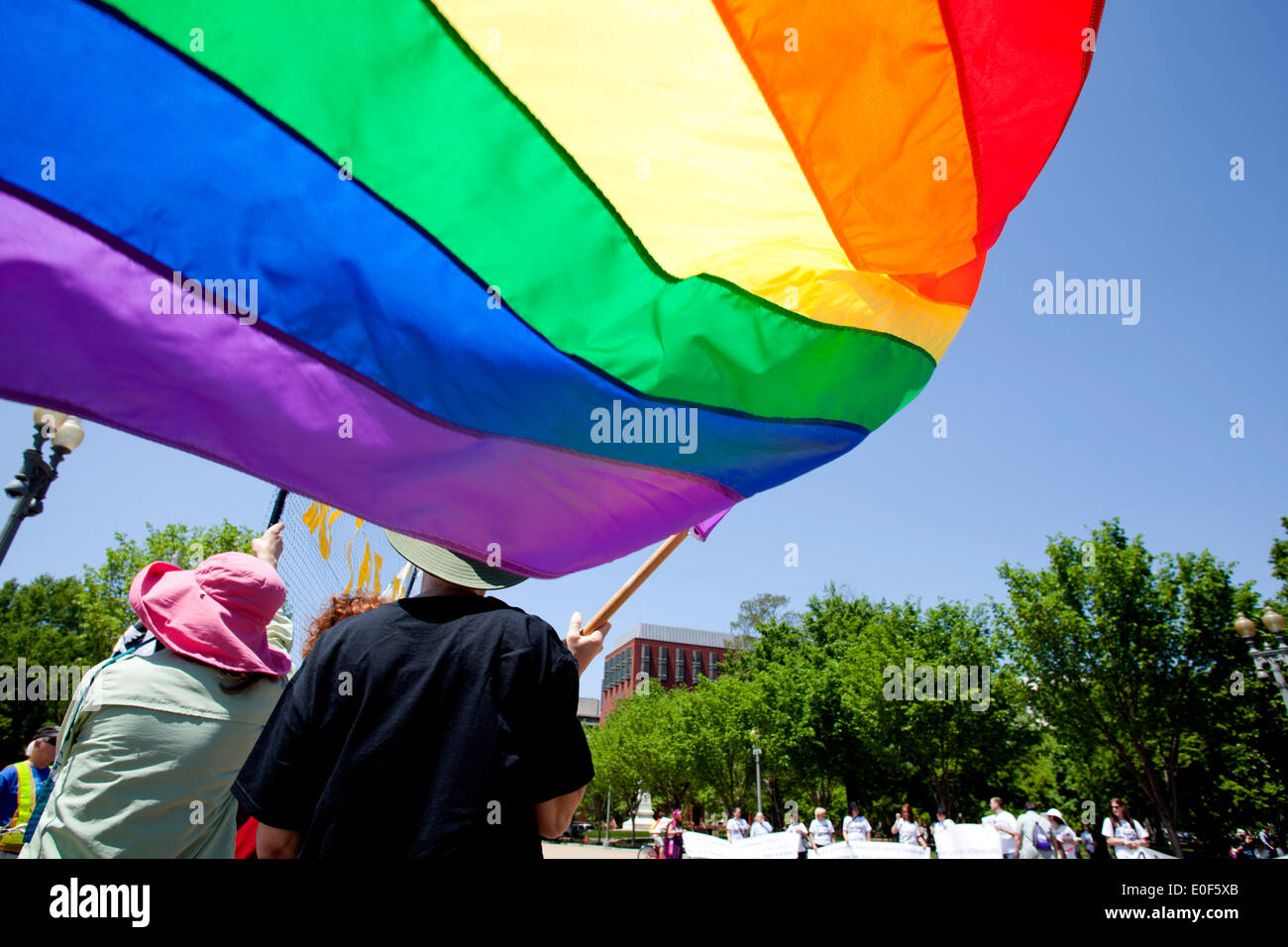 Person holding a rainbow flag at LGBT rally - Washington, DC USA Stock Photo