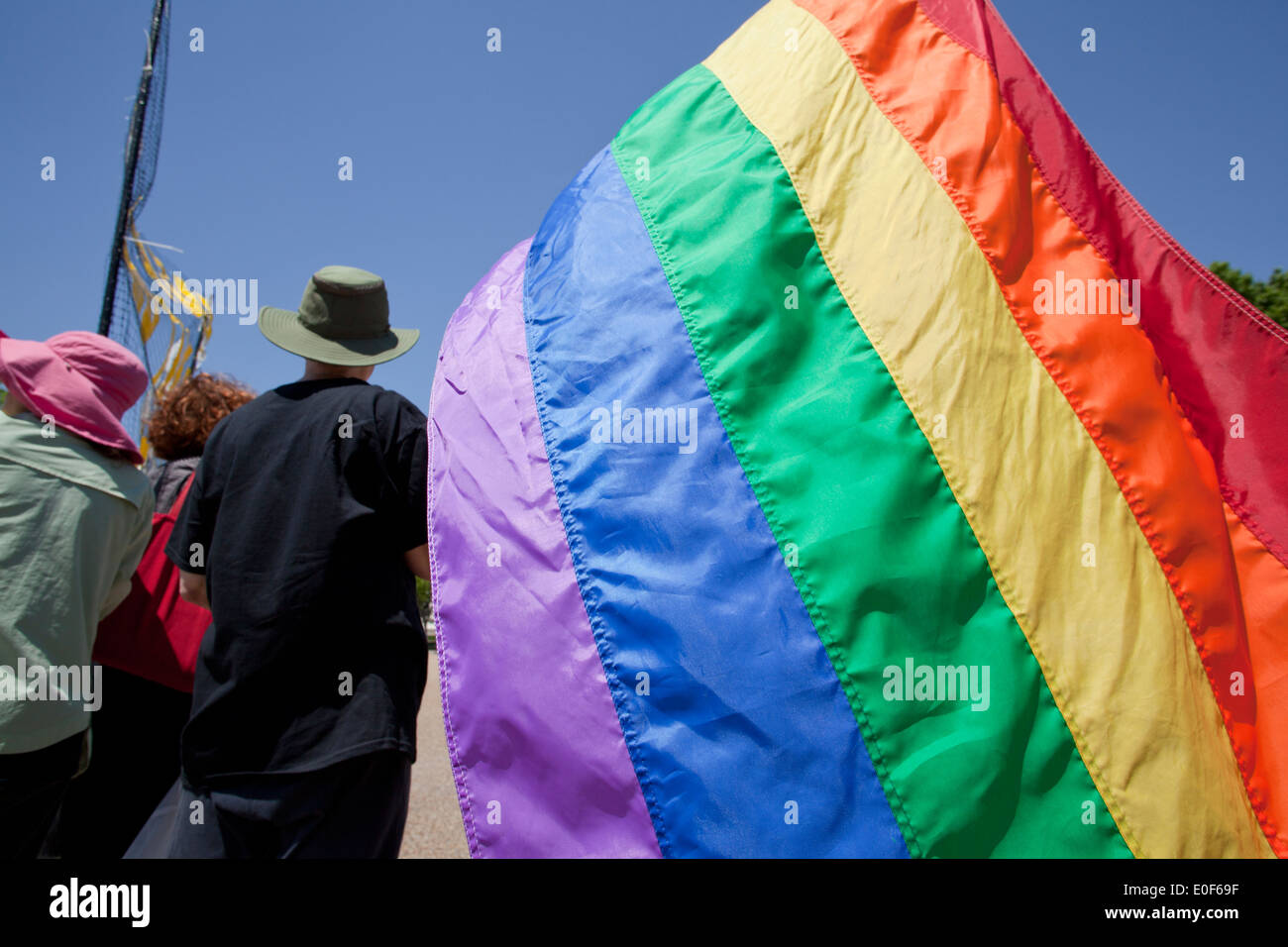 Person holding a rainbow flag at LGBT rally - Washington, DC USA Stock Photo