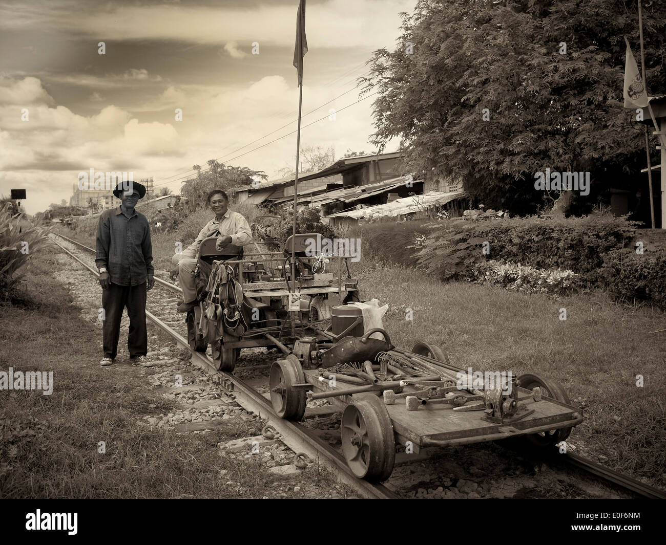 Sepia tinted image synonymous with a vintage photograph of old time railway workers. Thailand S. E. Asia Black and white photography Stock Photo