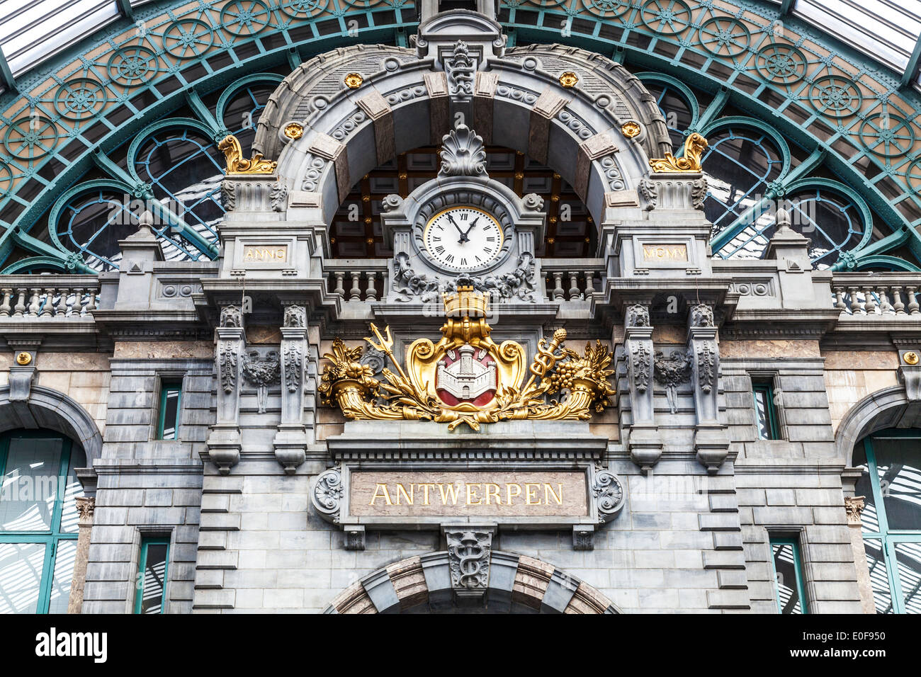 The clock above the entrance hall of the Antwerpen-Centraal railway station. Stock Photo