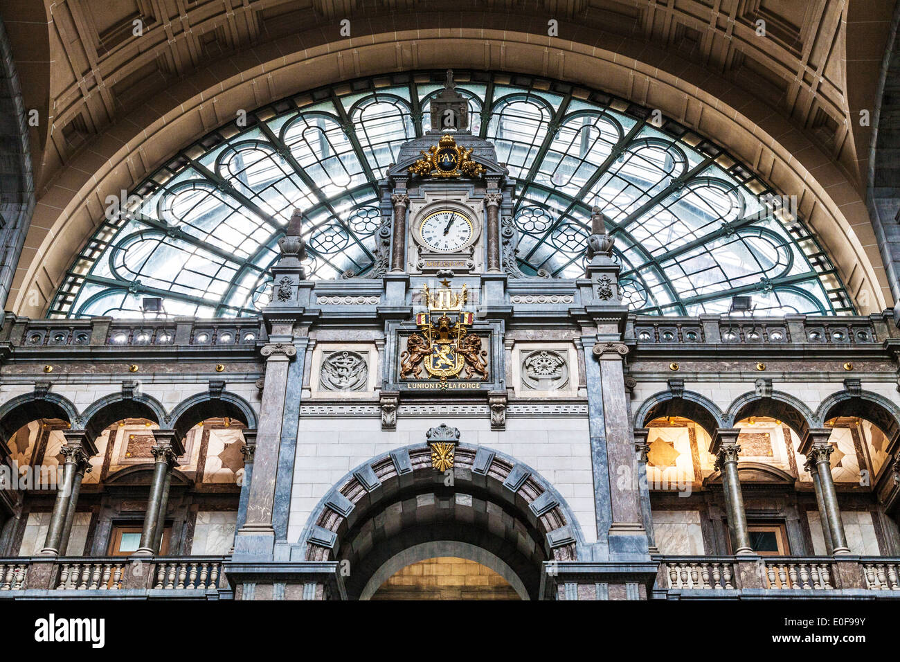 The clock above the entrance hall of the Antwerpen-Centraal railway station. Stock Photo
