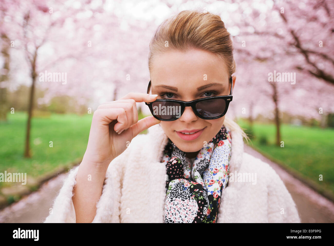 Close up image of beautiful young woman looking at camera. Young caucasian  female model looking through sunglasses. Stock Photo