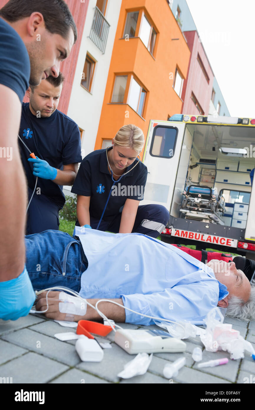 Paramedic examining unconscious patient hi-res stock photography and ...