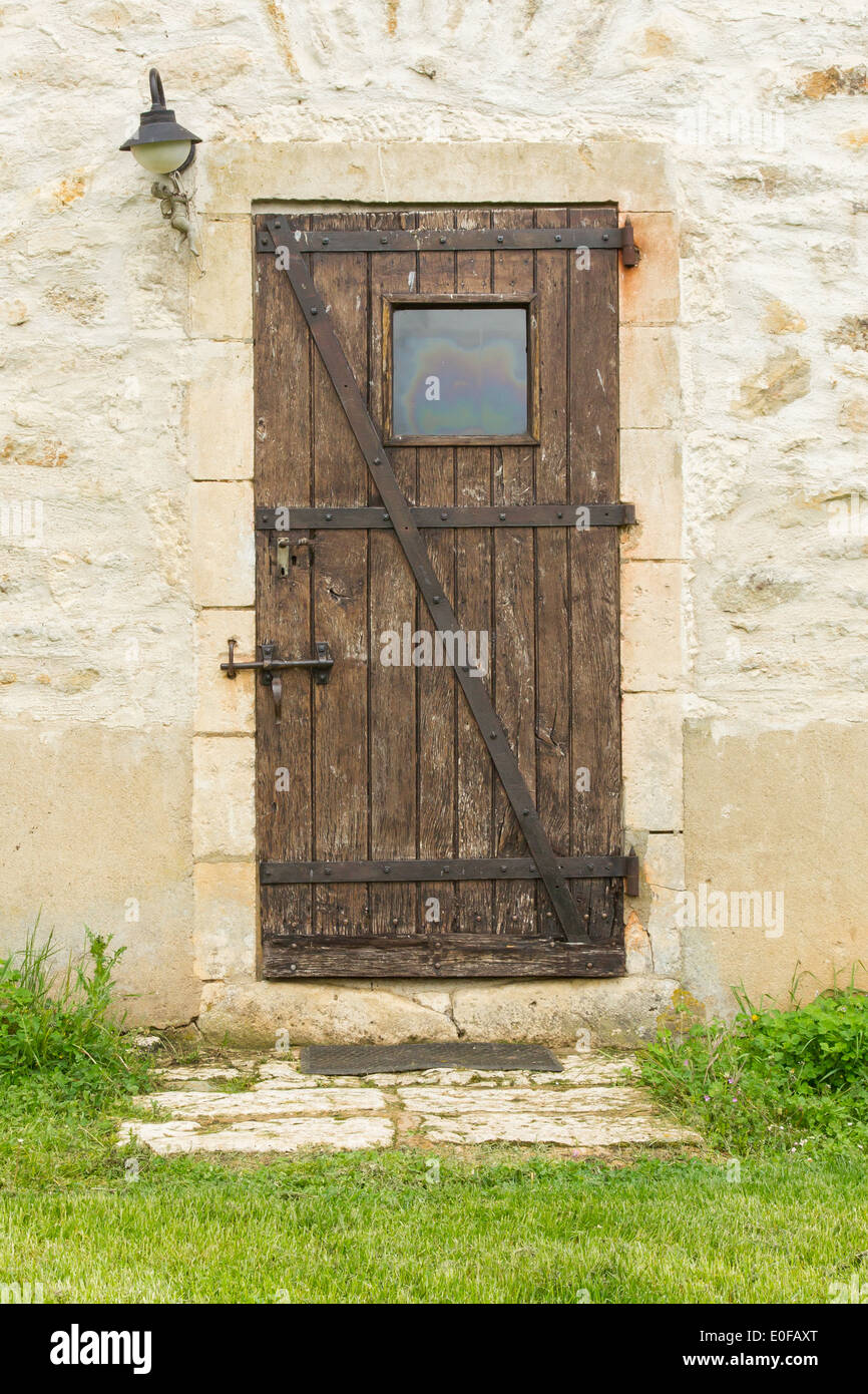 Old wooden door in an old stone wall Stock Photo - Alamy
