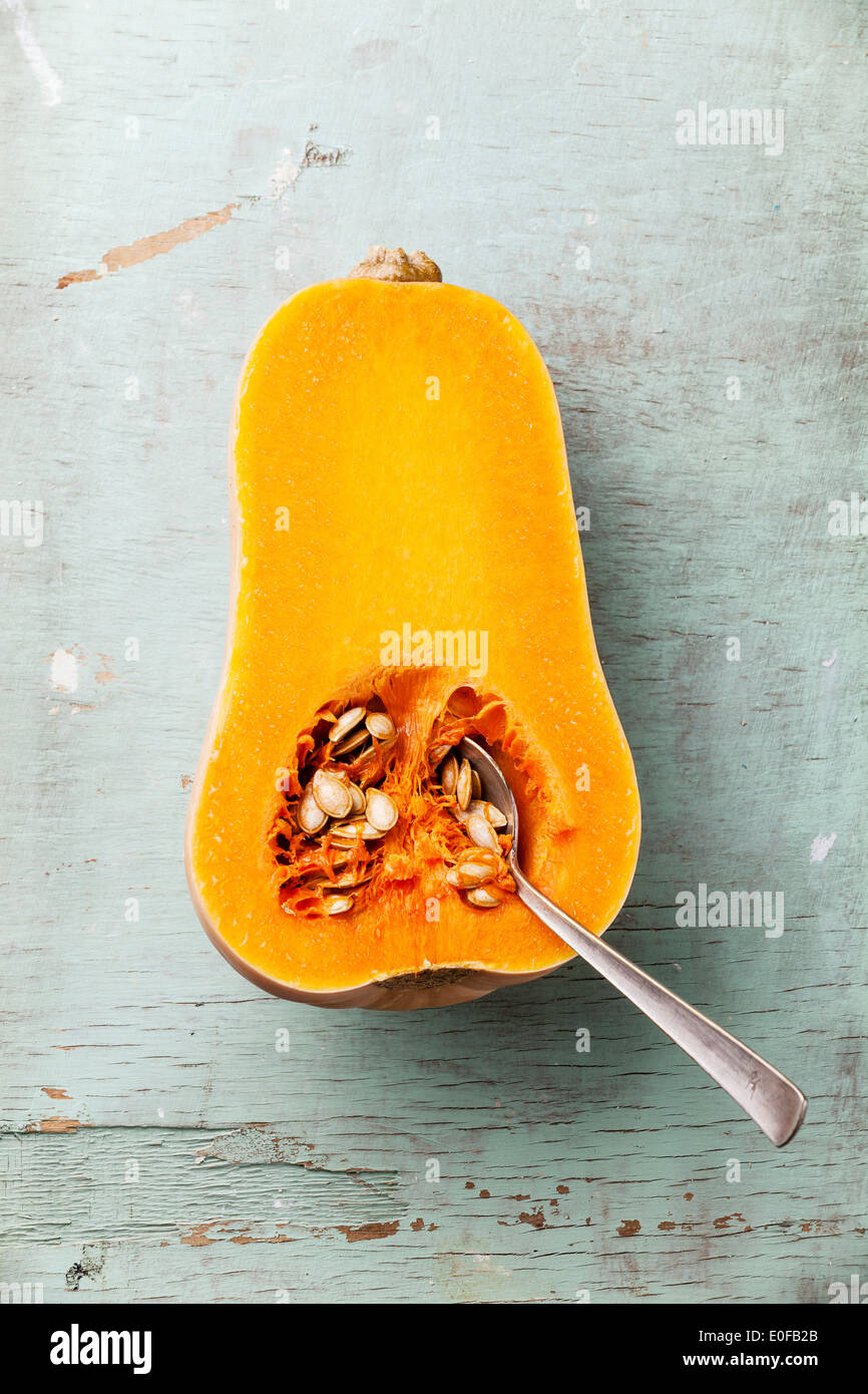 Half cut of ripe butternut squash on blue background Stock Photo